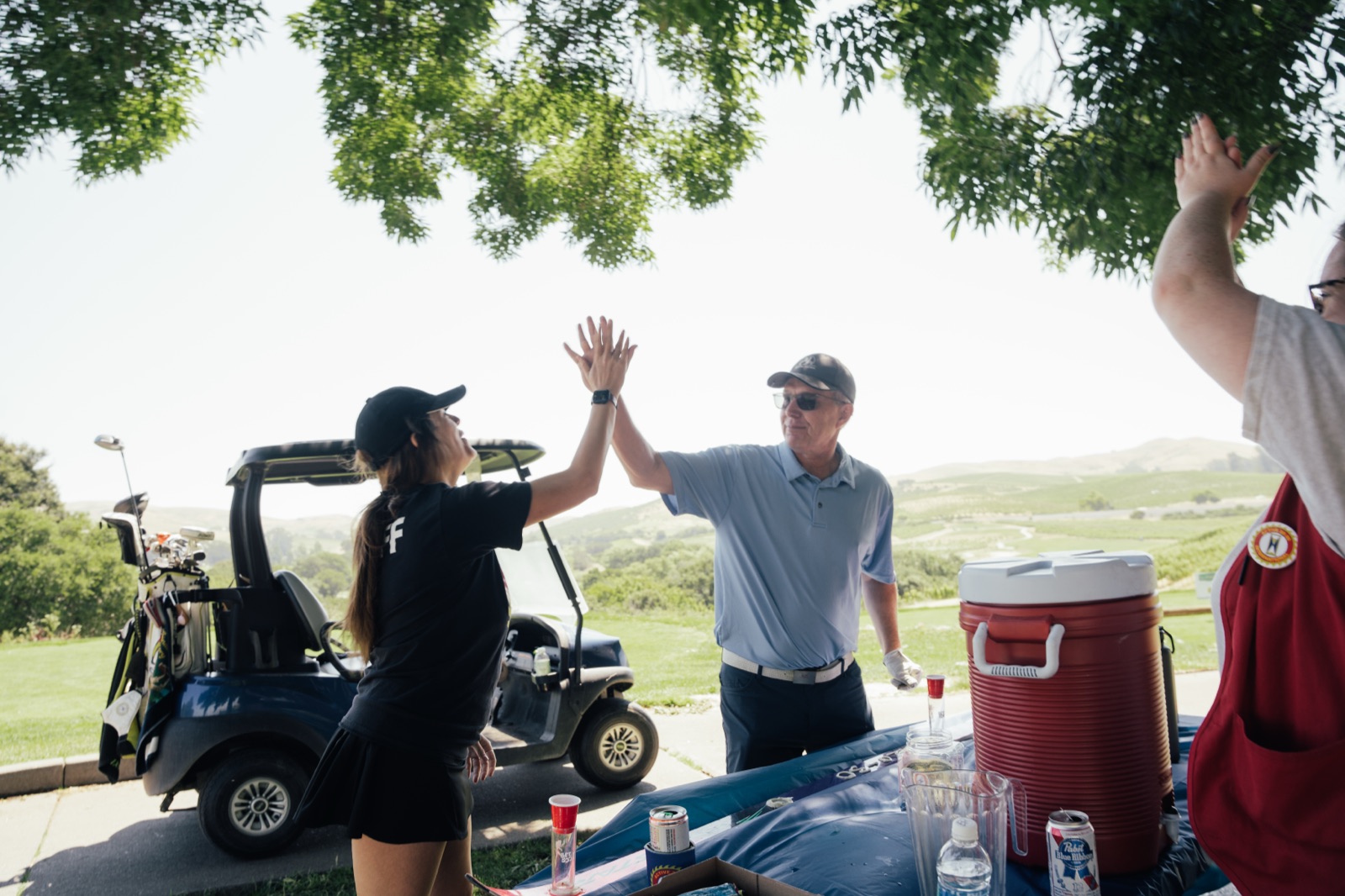 Club members celebrating with enthusiastic high-five