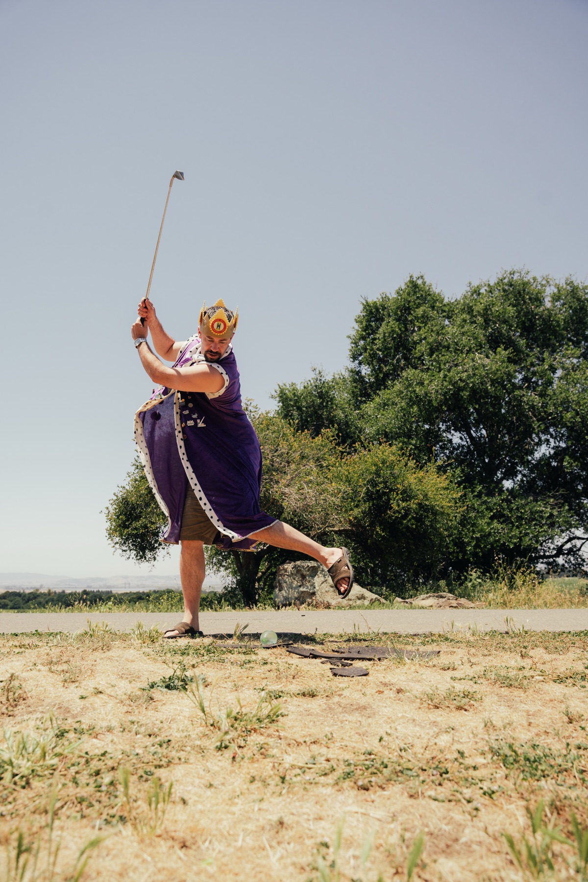 A member in full royal costume tees off at the Tee Off Fore Kids tournament
