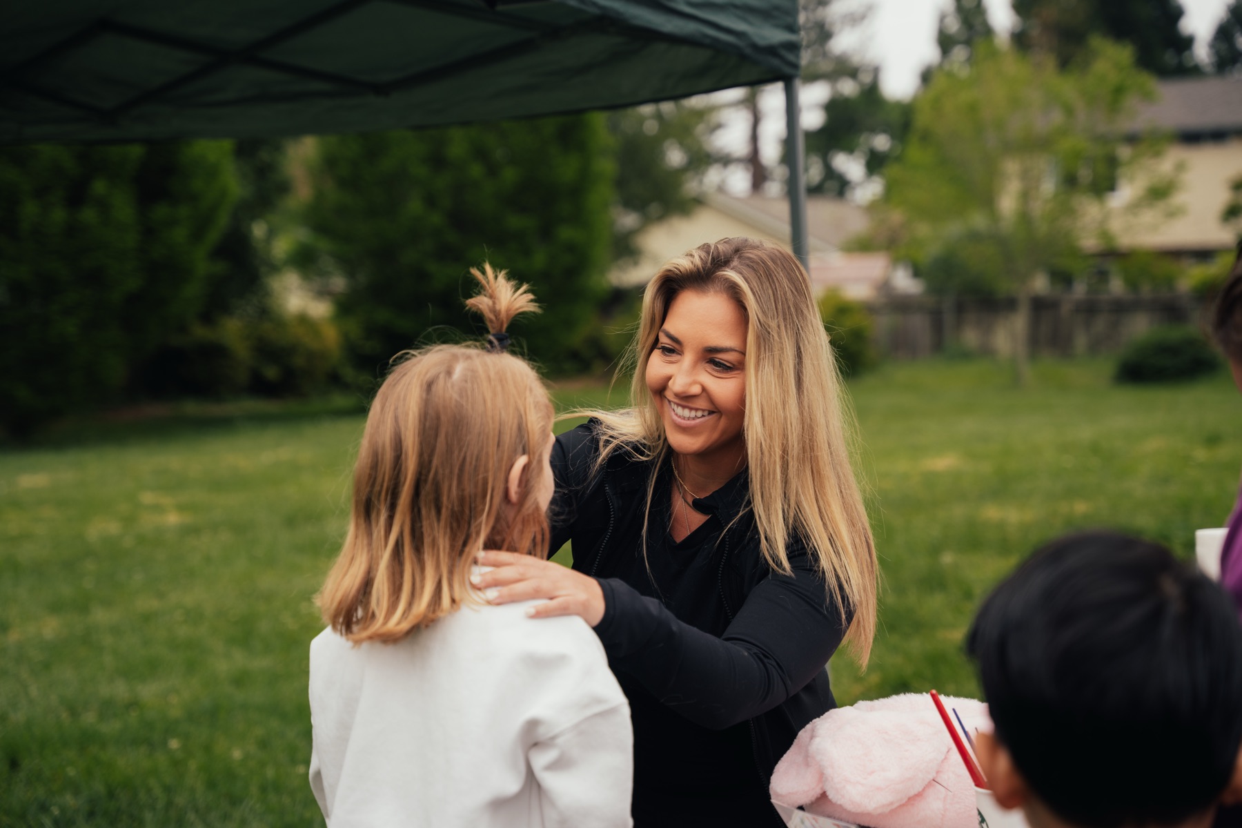 A club volunteer welcomes a young guest at the Easter egg hunt craft tent